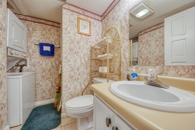 bathroom with stacked washer / dryer, a textured ceiling, vanity, and wallpapered walls