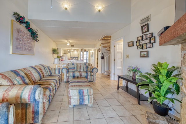 living room with light tile patterned flooring and a ceiling fan