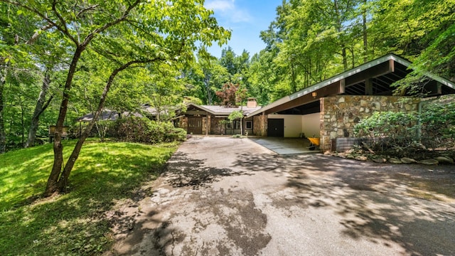 1115 Old Cartertown Rd, Road, Gatlinburg, TN 37738 - mid-century inspired home with asphalt driveway, stone siding, a front lawn, a chimney, and a carport