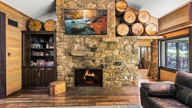 1115 Old Cartertown Rd, Road, Gatlinburg, TN 37738 - living area with wood walls, vaulted ceiling, hardwood / wood-style floors, and a stone fireplace