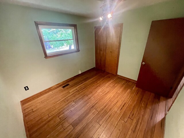 4124 Big Creek Rd, Hartford, TN 37753 - unfurnished bedroom with wood-type flooring, a closet, and baseboards