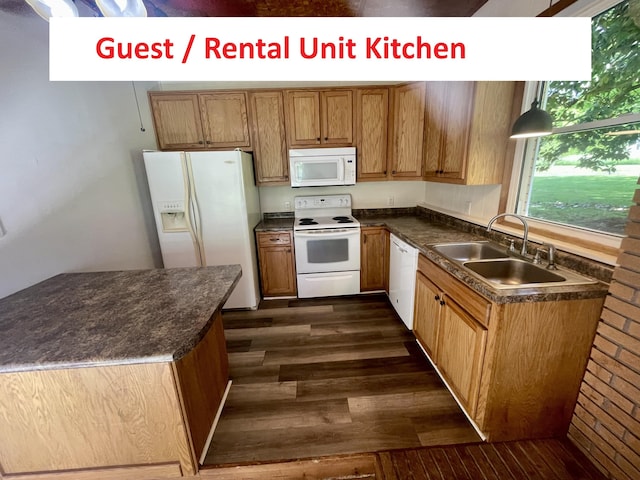 4124 Big Creek Rd, Hartford, TN 37753 - kitchen with white appliances, dark countertops, a sink, dark wood finished floors, and brown cabinetry