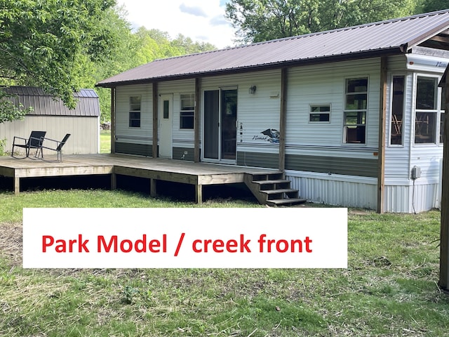 4124 Big Creek Rd, Hartford, TN 37753 - view of front facade with metal roof, a deck, and a front lawn