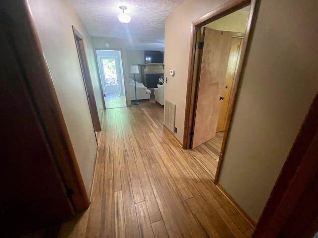 4124 Big Creek Rd, Hartford, TN 37753 - hallway featuring a textured ceiling and light wood-style floors