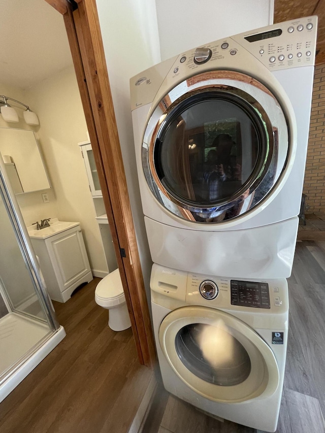 4124 Big Creek Rd, Hartford, TN 37753 - laundry area featuring stacked washer and clothes dryer and dark wood-style floors