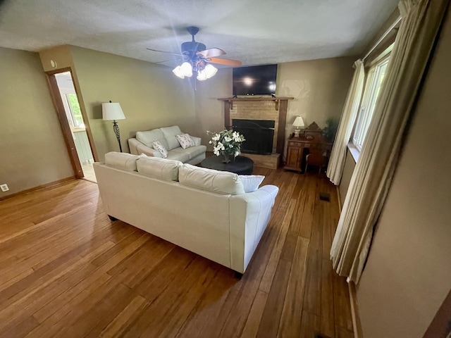 4124 Big Creek Rd, Hartford, TN 37753 - living room with a ceiling fan, a fireplace, and hardwood / wood-style flooring