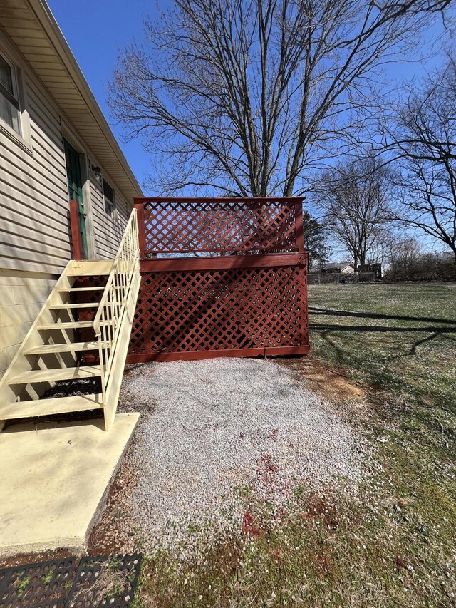 view of yard featuring stairway and a deck