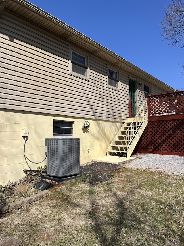 rear view of house featuring stairway, a wooden deck, and central air condition unit