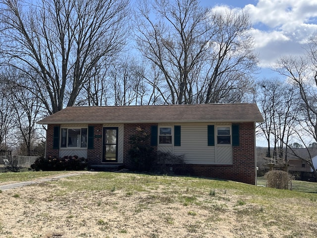 view of front of house with brick siding and a front lawn