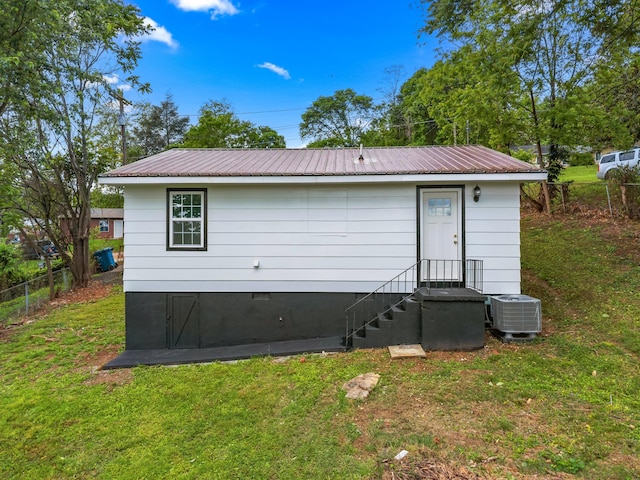 812 Donna St, Morristown, TN 37814 - rear view of house featuring metal roof, fence, a lawn, and central AC