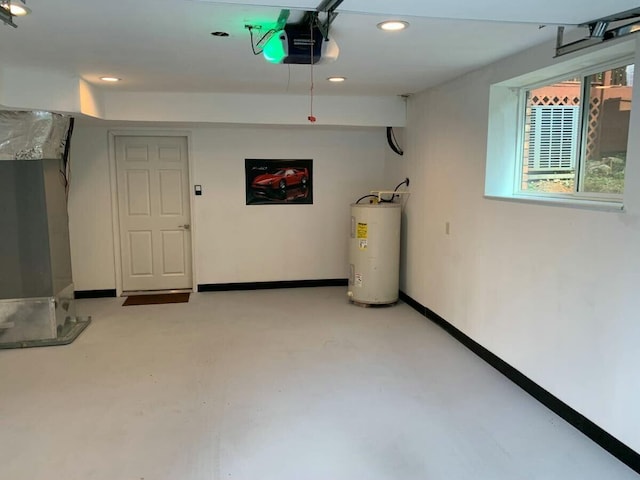 below grade area featuring a garage, water heater, baseboards, and recessed lighting