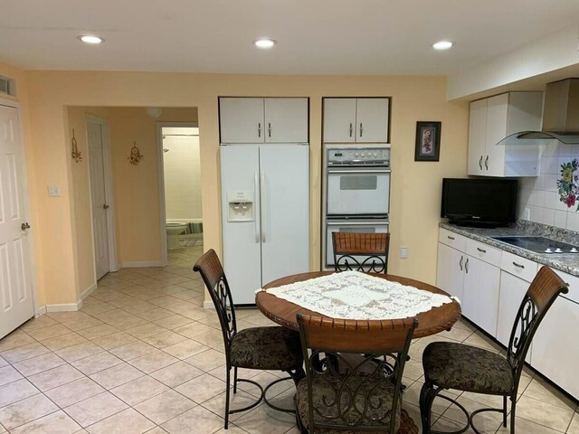 kitchen featuring white appliances, light tile patterned flooring, decorative backsplash, and recessed lighting