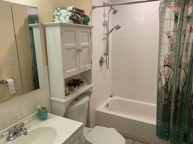 full bath featuring tasteful backsplash, shower / bathtub combination with curtain, toilet, and vanity