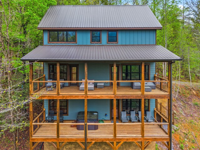 5276 Riversong Way, Sevierville, TN 37876 - rear view of house featuring a wooden deck, a balcony, and metal roof