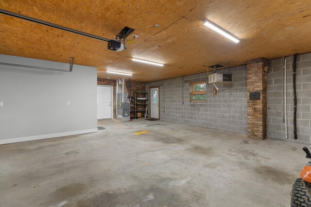 1327 Clinch View Cir, Jefferson City, TN 37760 - garage featuring a garage door opener, concrete block wall, and heating unit