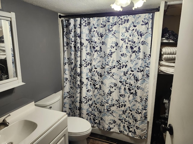 bathroom with vanity, a shower with shower curtain, a textured ceiling, and toilet