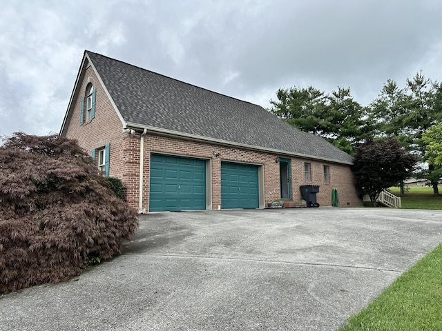 4815 Stapleton Rd, Morristown, TN 37813 - view of side of property with brick siding, concrete driveway, a shingled roof, and a garage