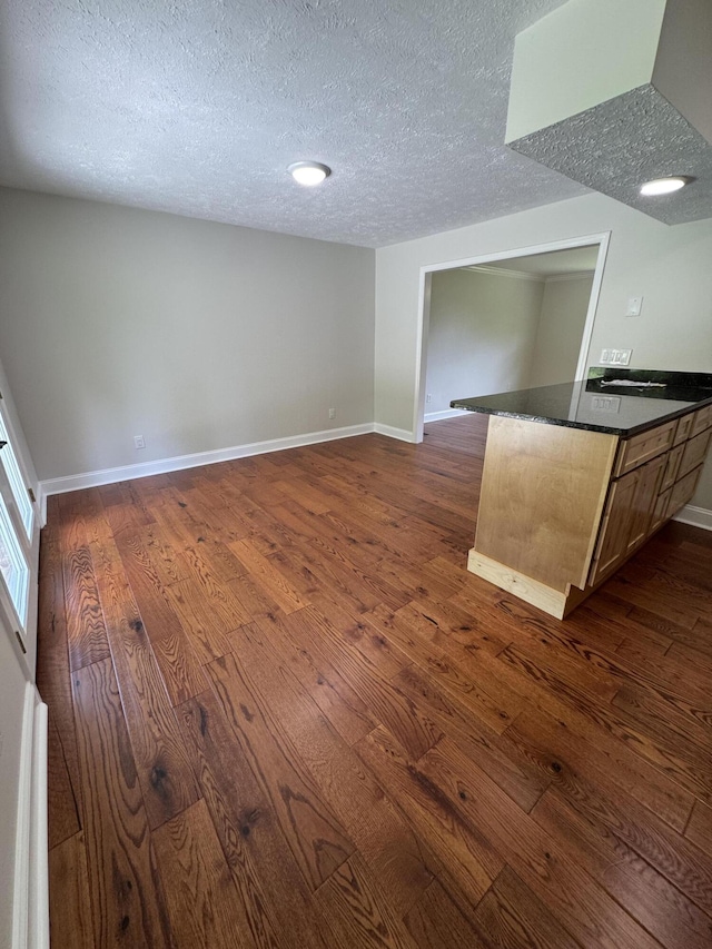 2276 White Oak Grove Rd, Morristown, TN 37813 - kitchen featuring a textured ceiling, dark countertops, dark wood-type flooring, baseboards, and open floor plan