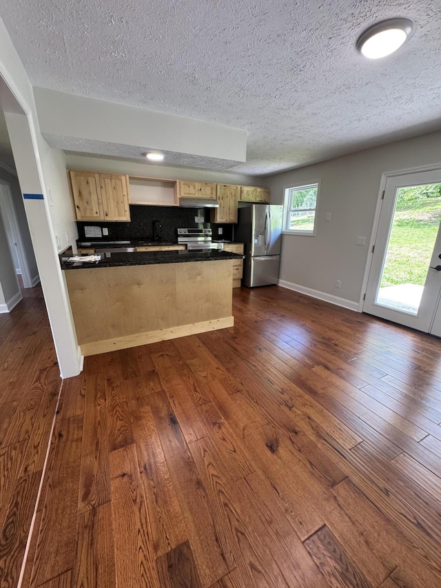 2276 White Oak Grove Rd, Morristown, TN 37813 - kitchen with appliances with stainless steel finishes, a peninsula, light brown cabinetry, a textured ceiling, and dark countertops