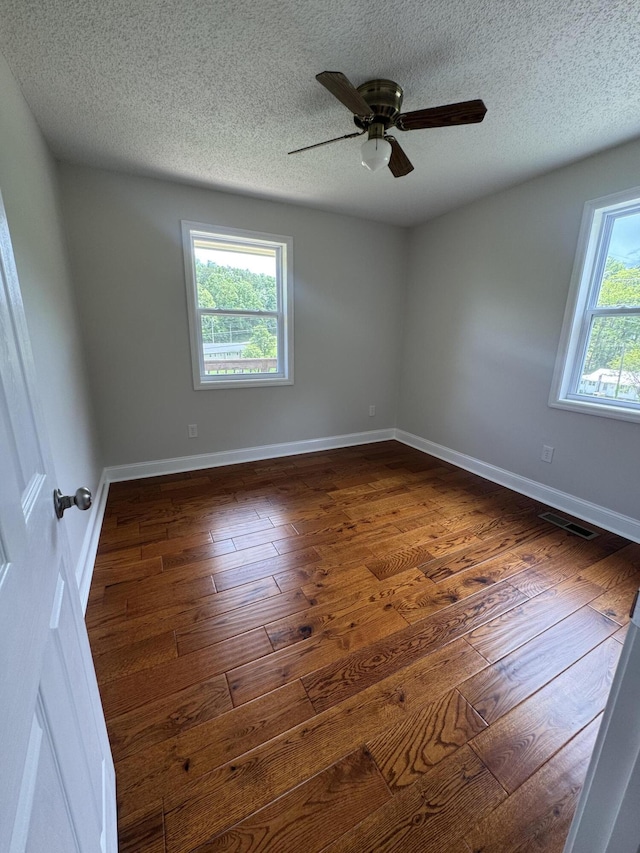 2276 White Oak Grove Rd, Morristown, TN 37813 - unfurnished room featuring a textured ceiling, dark wood-style floors, ceiling fan, and baseboards