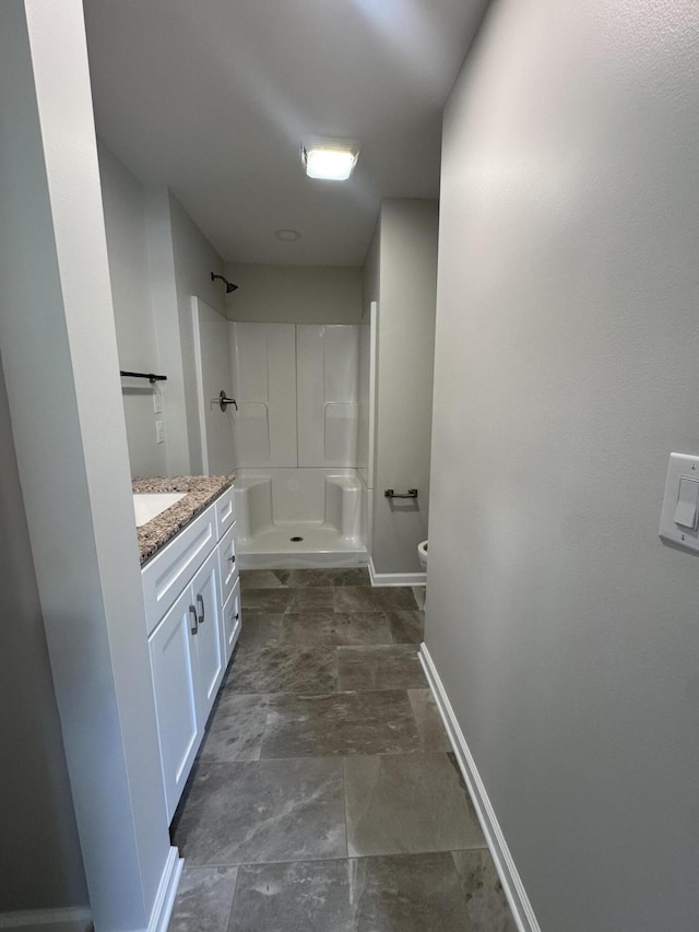2276 White Oak Grove Rd, Morristown, TN 37813 - full bathroom featuring a stall shower, baseboards, toilet, vanity, and stone finish floors