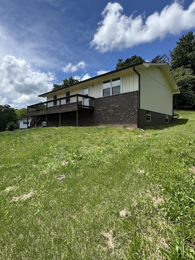 2276 White Oak Grove Rd, Morristown, TN 37813 - rear view of house featuring a deck, brick siding, and a lawn