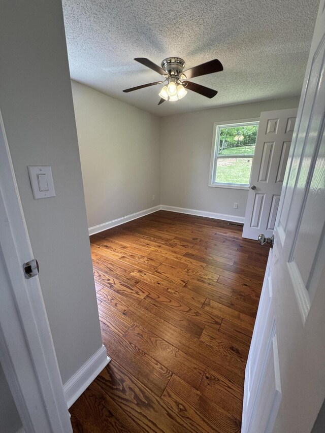 2276 White Oak Grove Rd, Morristown, TN 37813 - empty room featuring a ceiling fan, baseboards, a textured ceiling, and dark wood-style flooring