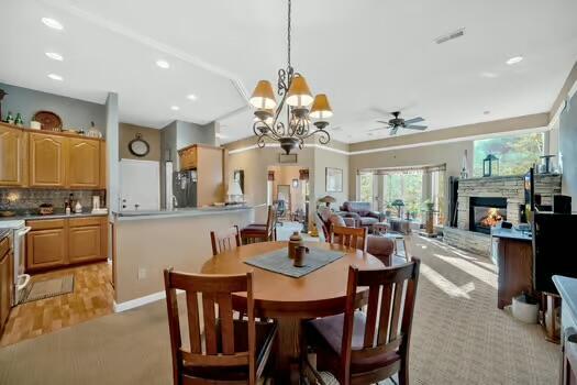 dining space with recessed lighting, a fireplace, visible vents, baseboards, and a ceiling fan