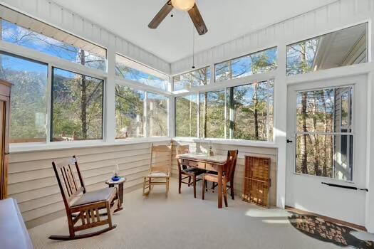 sunroom / solarium featuring a ceiling fan