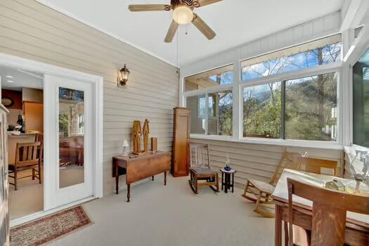 sunroom / solarium featuring ceiling fan