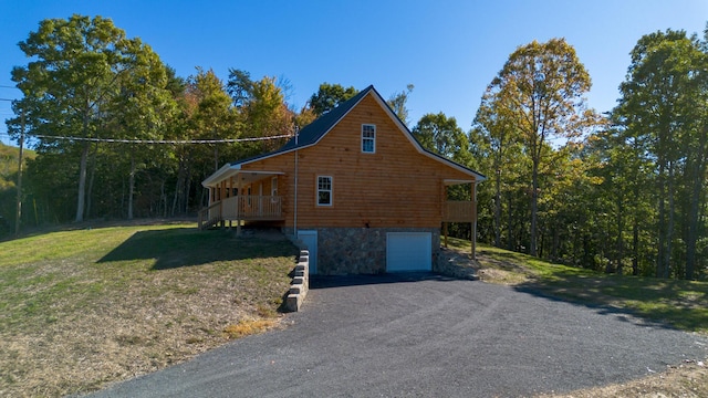 view of property exterior featuring a lawn and a garage