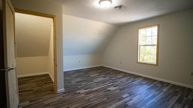 bonus room with dark hardwood / wood-style floors and lofted ceiling