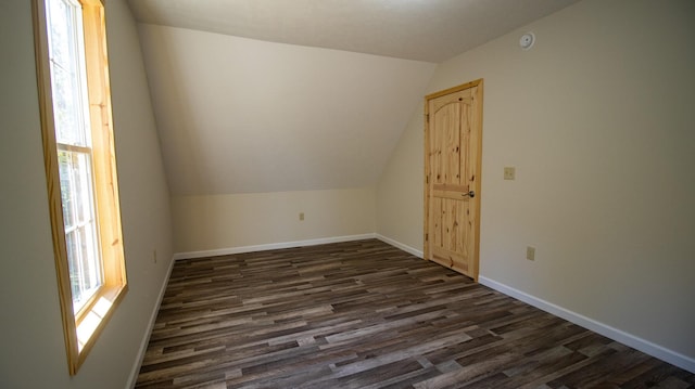 bonus room with vaulted ceiling and dark hardwood / wood-style floors