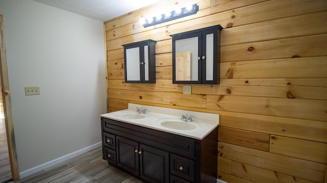 bathroom featuring wood walls, vanity, and hardwood / wood-style flooring