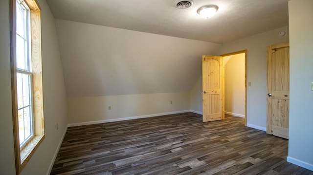 bonus room with dark hardwood / wood-style floors, a wealth of natural light, and lofted ceiling