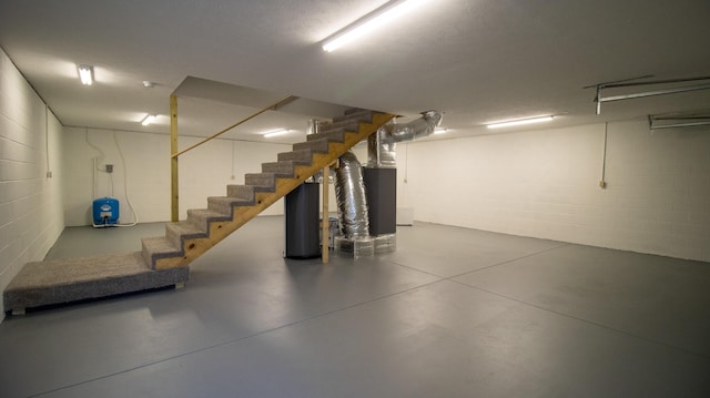 basement featuring heating unit and water heater