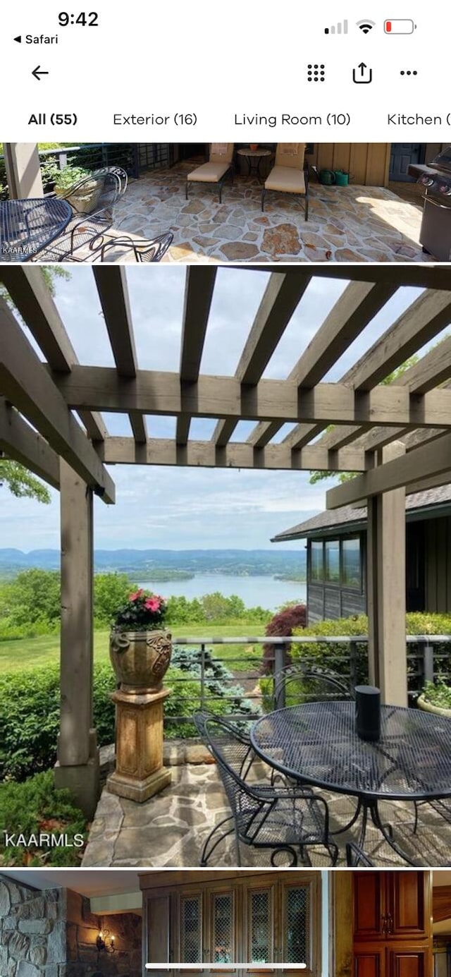 view of patio featuring a pergola and a water view