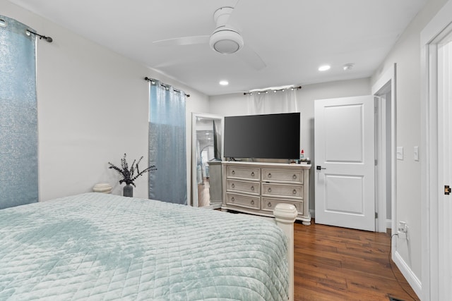 bedroom with dark hardwood / wood-style flooring, ensuite bath, and ceiling fan