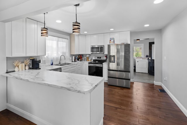 kitchen featuring kitchen peninsula, white cabinets, and appliances with stainless steel finishes