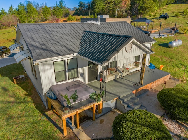 back of property featuring a lawn and a wooden deck