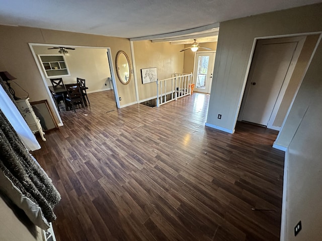 empty room with ceiling fan and dark hardwood / wood-style flooring