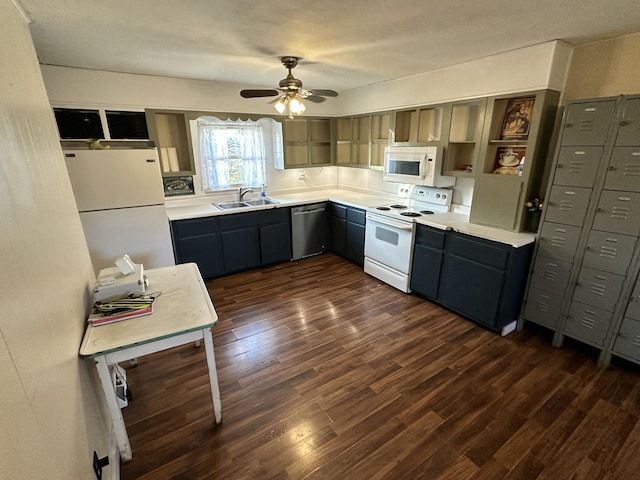 kitchen featuring ceiling fan, sink, dark hardwood / wood-style floors, and white appliances