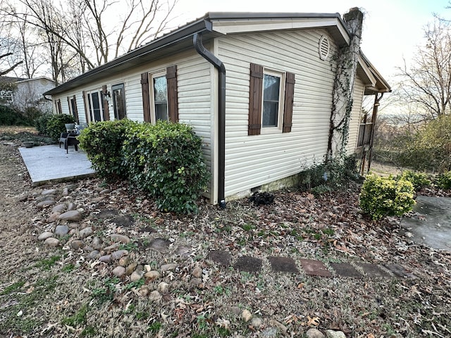 view of property exterior with a patio