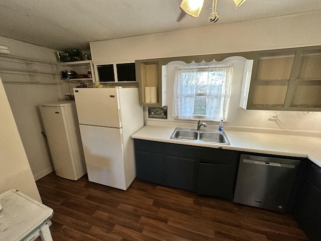 kitchen featuring white refrigerator, dark hardwood / wood-style floors, stainless steel dishwasher, and sink