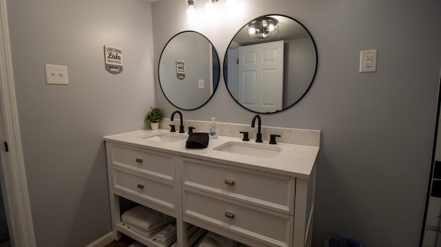bathroom with a sink and double vanity