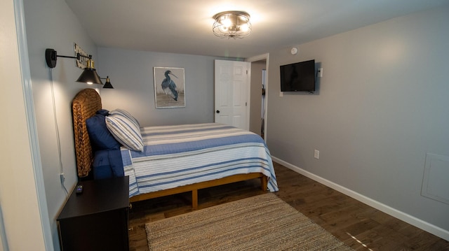 bedroom featuring wood finished floors and baseboards