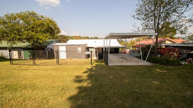 view of yard with a carport and fence
