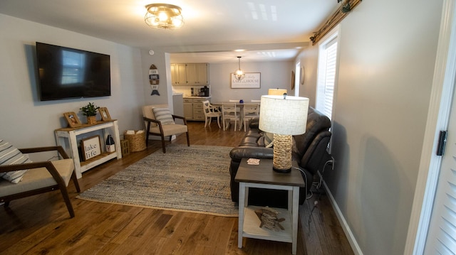 living area featuring baseboards and dark wood-style flooring