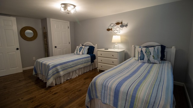 bedroom featuring baseboards and dark wood-style floors