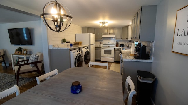 kitchen featuring white electric range oven, washer and clothes dryer, backsplash, gray cabinetry, and light countertops